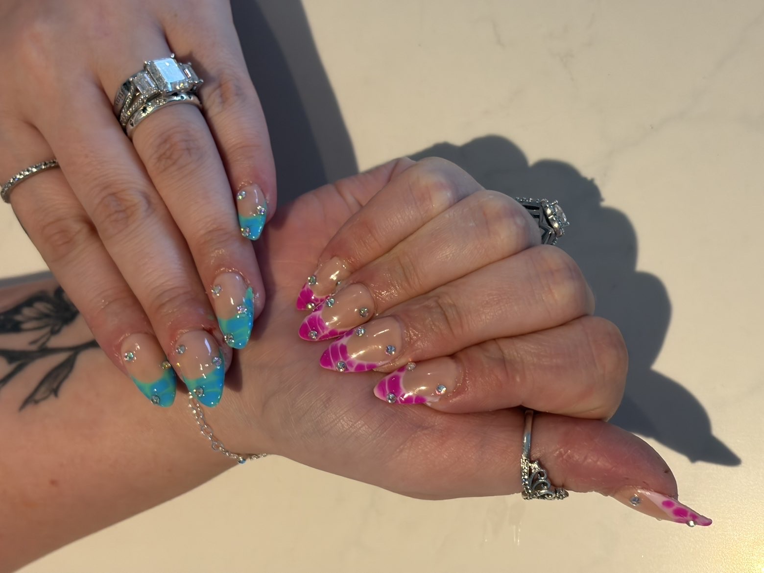 Teal and magenta marble French tips with gems
